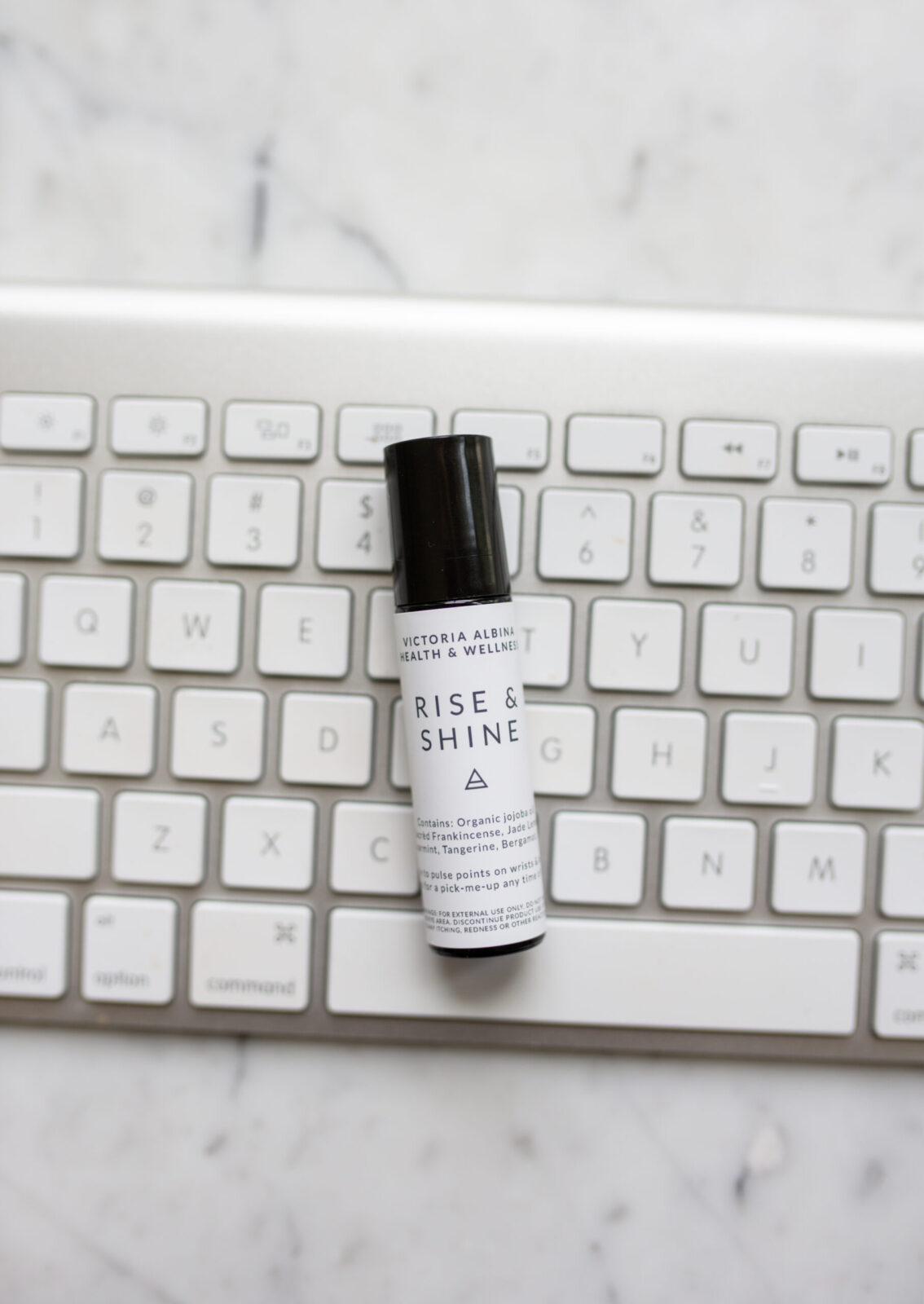 Rise and shine essential oil roller on keyboard