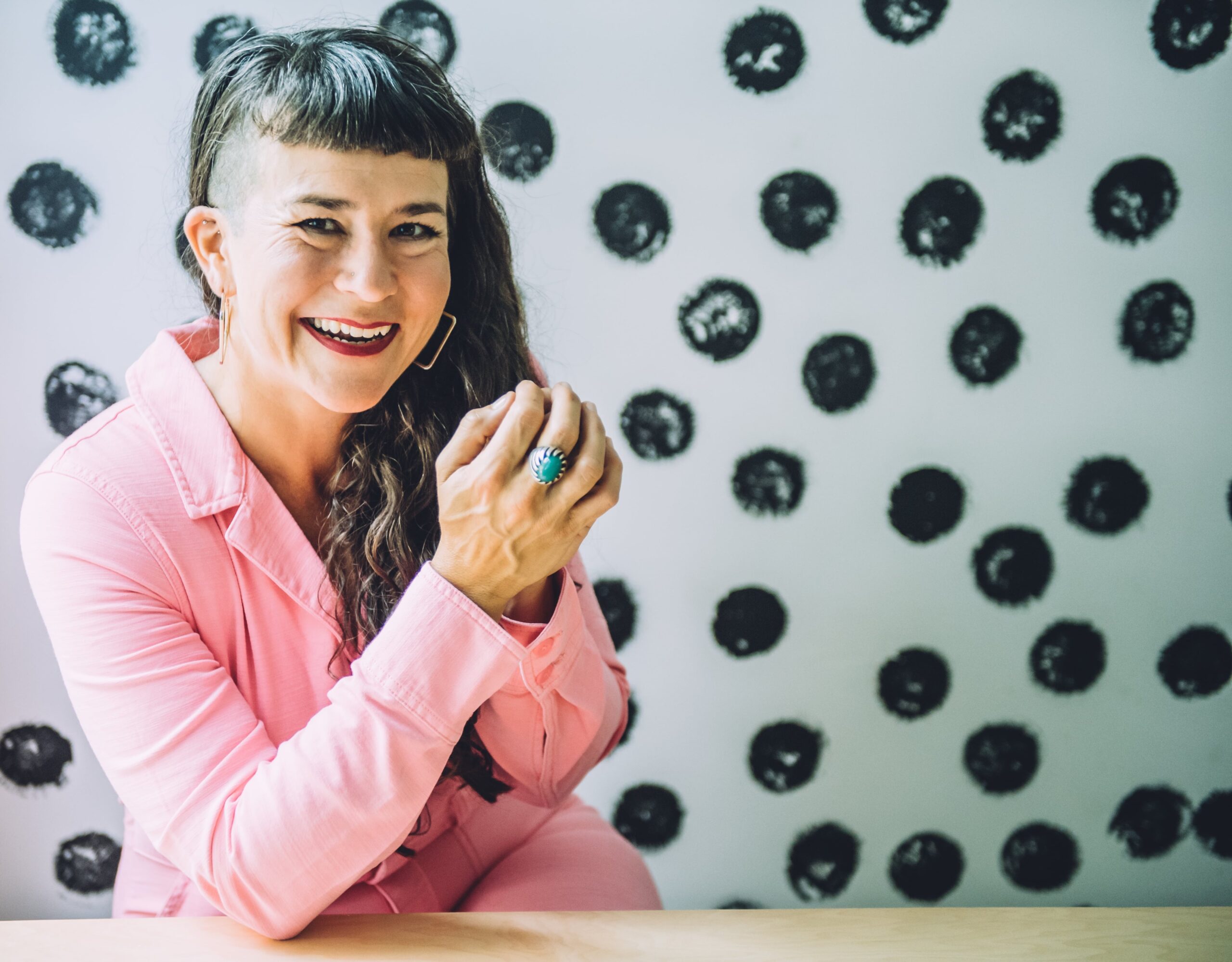 victoria-albina-thank-you-page Life coach Beatriz Victoria Albina wearing pink coveralls sitting in front of a polka dot wall