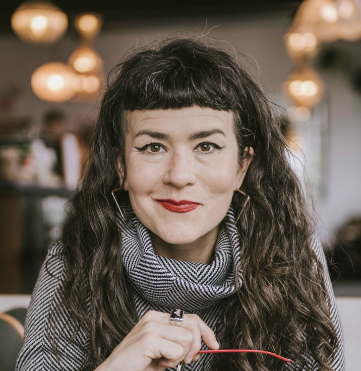 Bea Albina headshot Red glasses